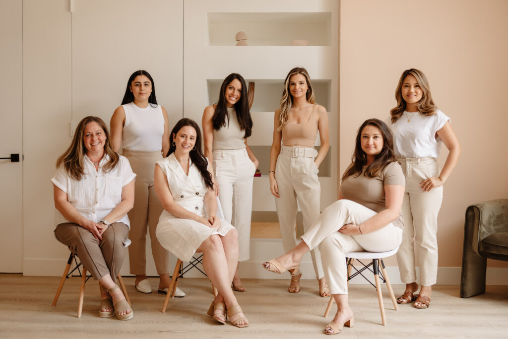 SMILELOUNGE dental team posing in stylish neutral outfits in Brooklyn, NY