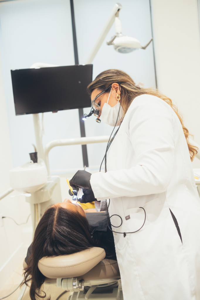 Dentist performing treatment with LED light at SMILELOUNGE in Brooklyn, NY