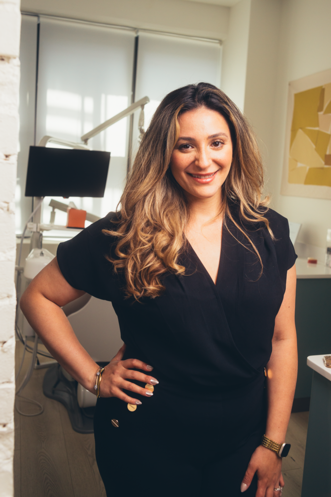 Dr. Kareema Roushdy at SMILELOUNGE dental clinic in Brooklyn, NY with treatment equipment
