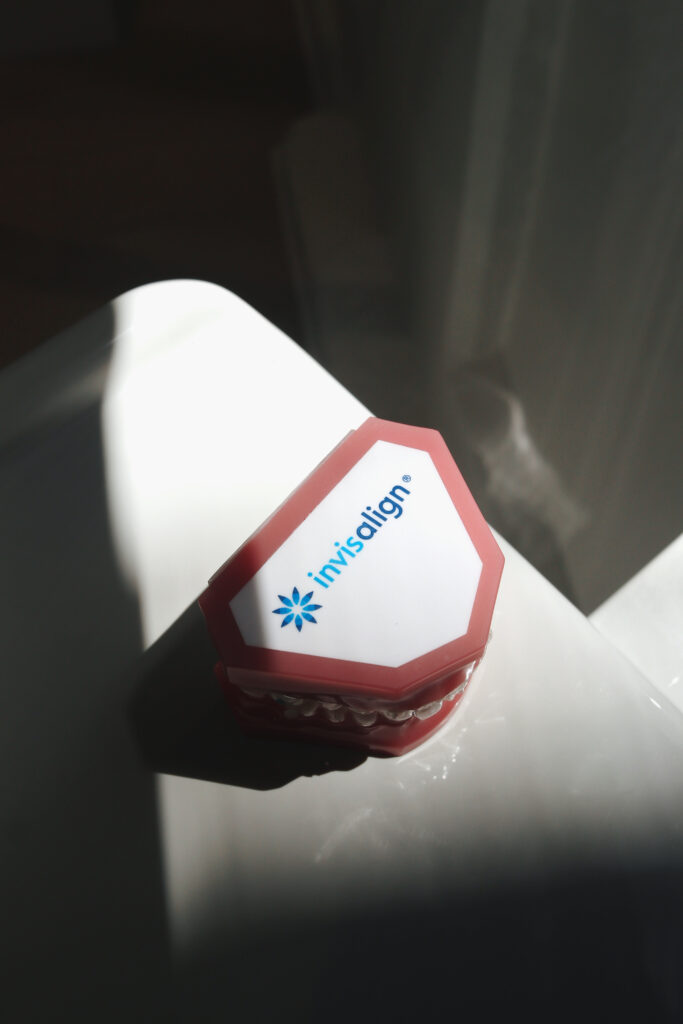 Invisalign dental model on white surface at SMILELOUNGE in Brooklyn, NY