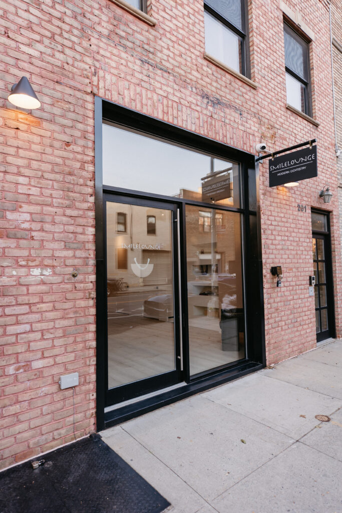 SMILELOUNGE storefront with black framed glass doors in Brooklyn, NY