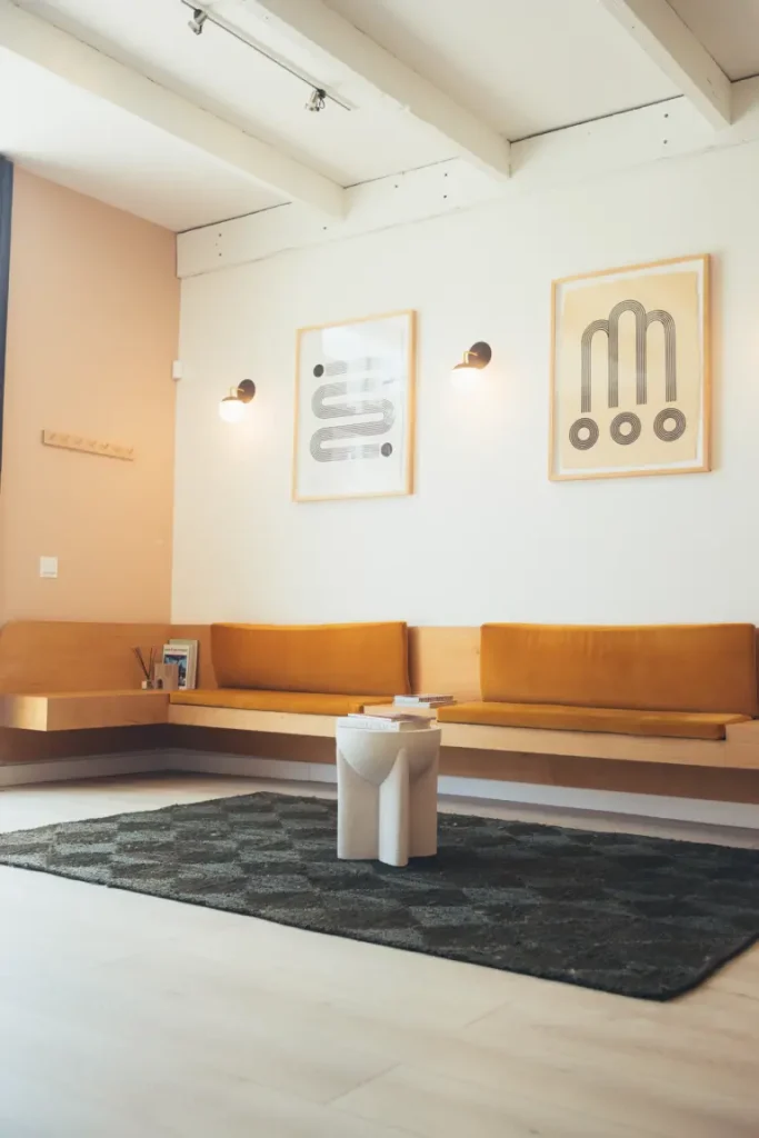 Modern dental office waiting room with warm wood seating, minimalist artwork, and a calm, welcoming design for patient comfort.